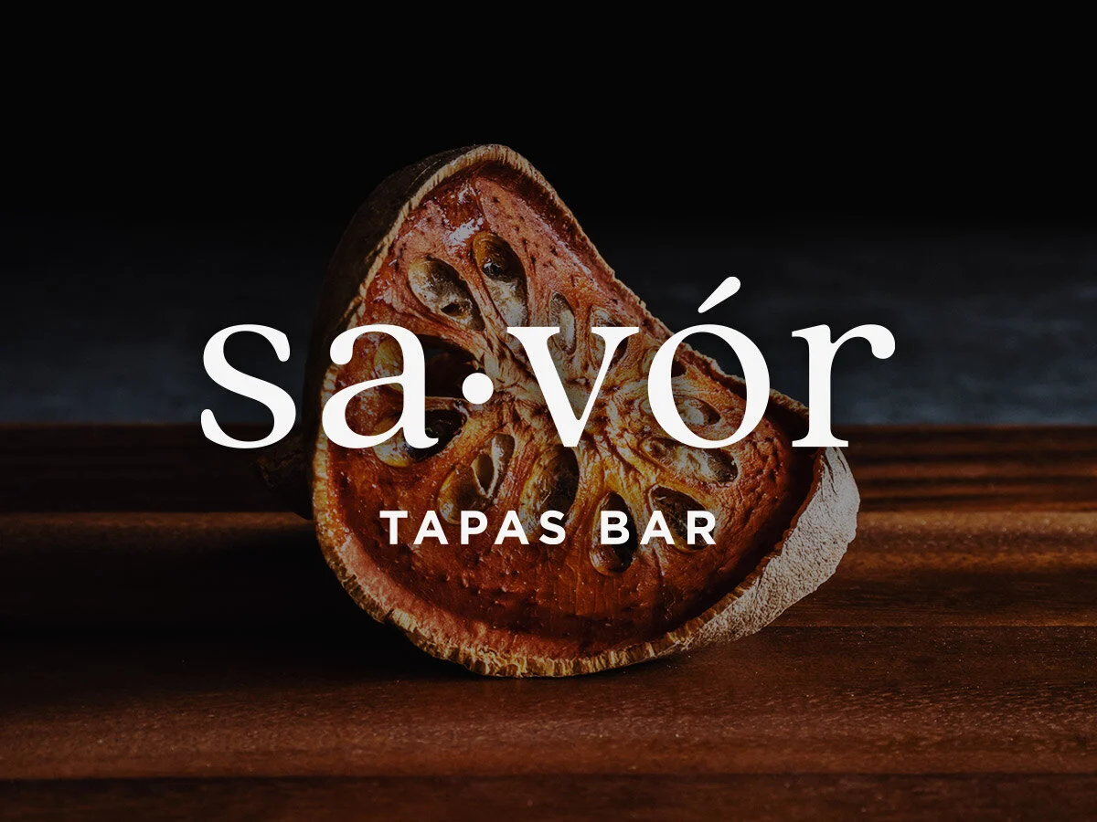 Savor Tapas Bar wordmark over a dried citrus slice