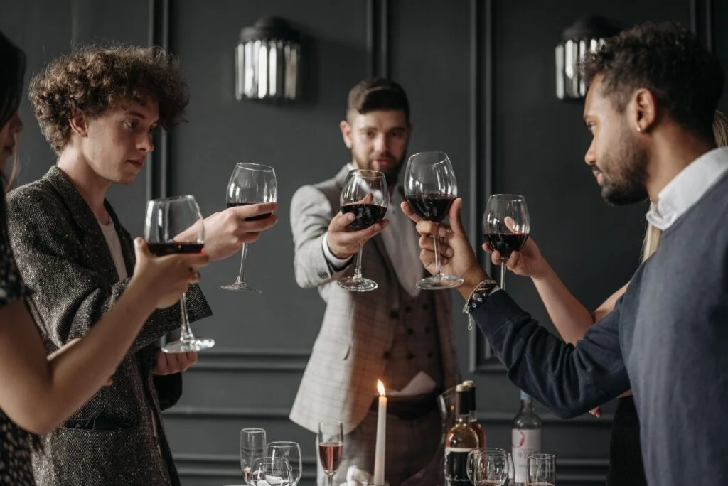 Friends raising glasses of red wine in a toast